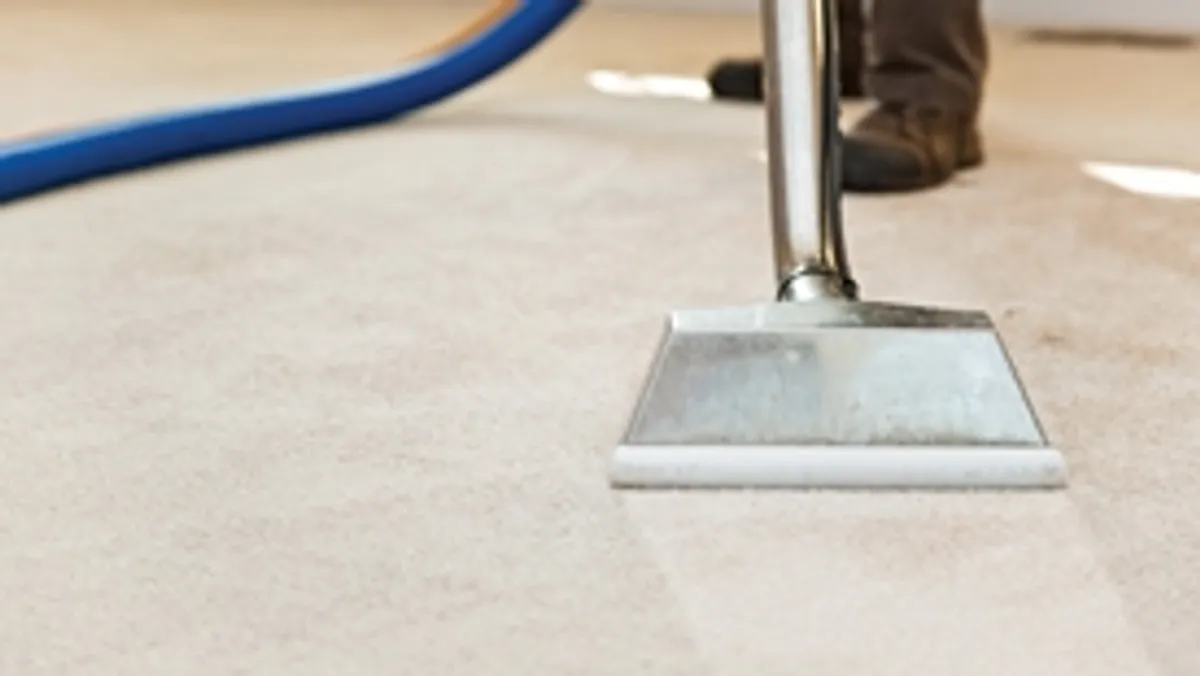 Carpet cleaning wand head gliding over a light carpet during hot-water extraction, Oakland, CA.
